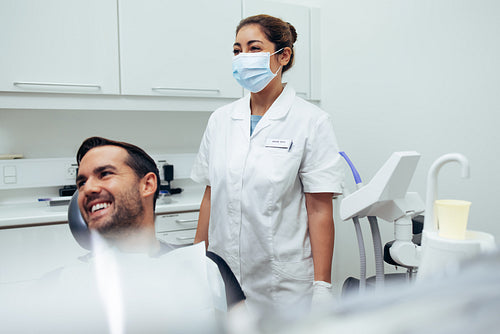 Happy young man visiting dentist
