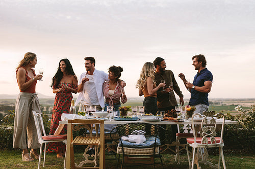 Millennials enjoying dinner party outdoors