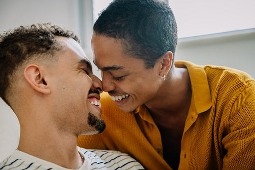 Smiling couple embracing at home in loving moment
