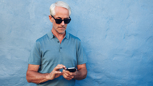 Mature man using mobile phone 