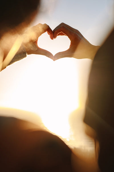 Couple in love gesturing heart with fingers