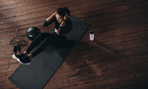 Female doing abdomen workout at the gym