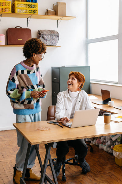 Colleagues collaborating in a sunny co-working office space