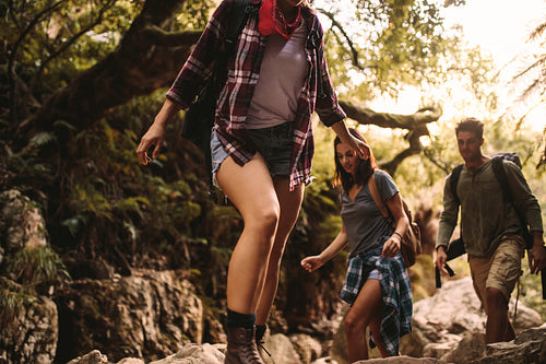 Friends trekking through a rocky trail in mountain