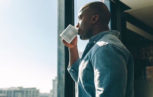 Businessman having coffee in modern office