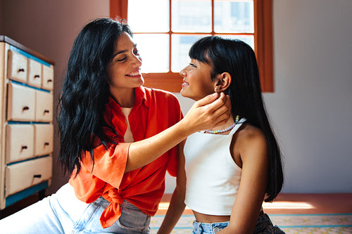 Mother and daughter sharing a joyful moment together indoors