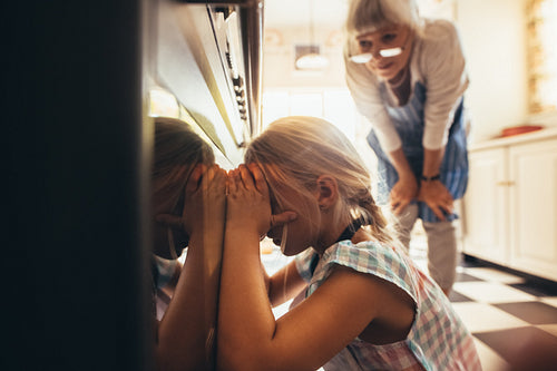 Kid looking inside an oven