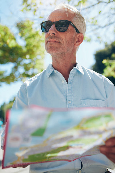 Mature tourist with a city map