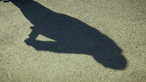 Shadow of protest movement on asphalt