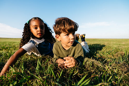 Playful children outdoors exploring friendship in a sunny field