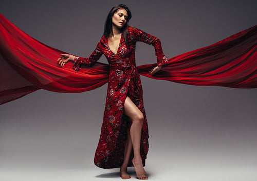 Fashion woman in fluttering red long dress
