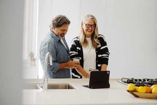 Senior couple using a tablet together at home
