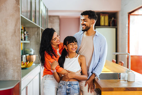 Happy family smiling together in a modern kitchen environment