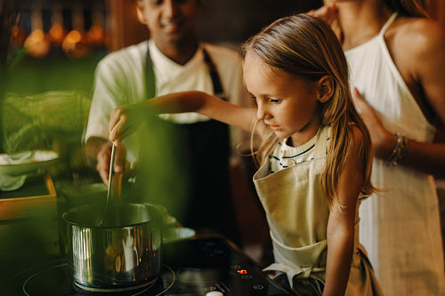 Mother and young boy learn to cook in vacation resort kitchen