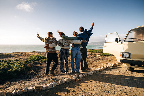 Friends celebrate a fun moment together on their road trip