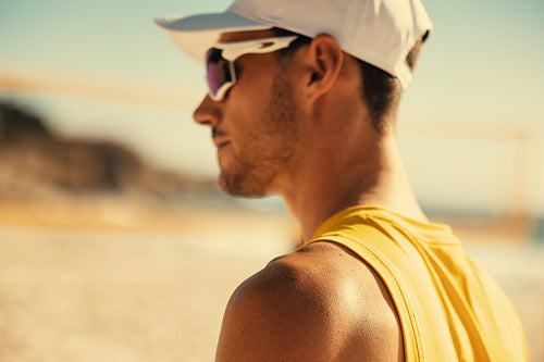 International athlete competing in beach volleyball championship on coastal sand court
