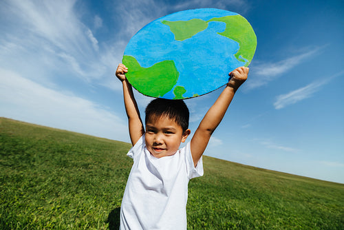 Boy holding globe symbolizing care for the planet
