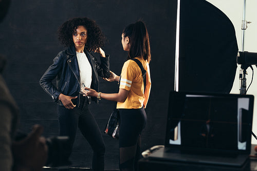 Stylist adjusting model during a fashion shoot
