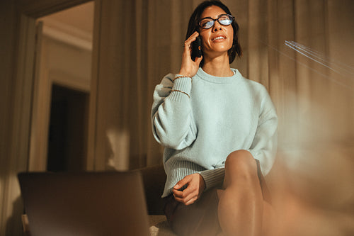 Businesswoman manages a phone call in the office at evening time