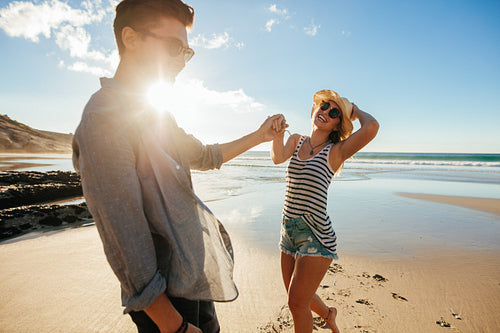 Beautiful young couple having fun on the beach