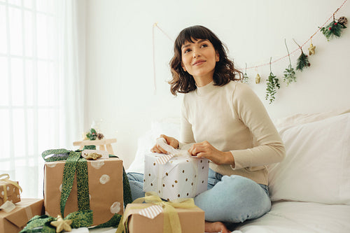 Woman decorating christmas presents