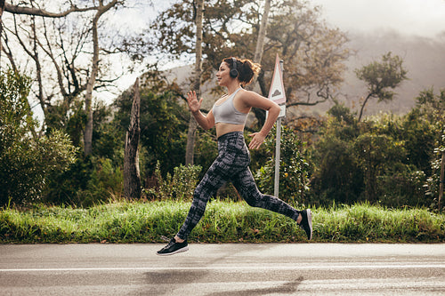 Female in sportswear running outdoors in morning