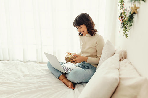 Happy woman doing a video call showing her christmas gift
