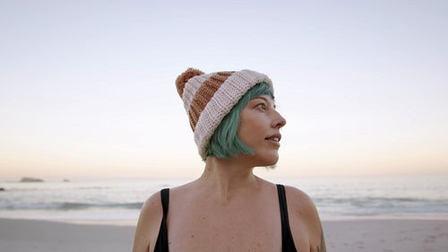 Mature woman looking around on the beach