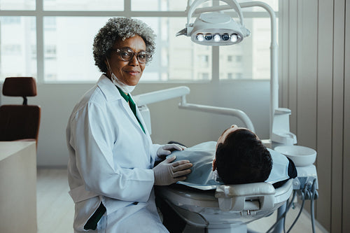 Dentist with senior patient during dental consultation in a modern clinic