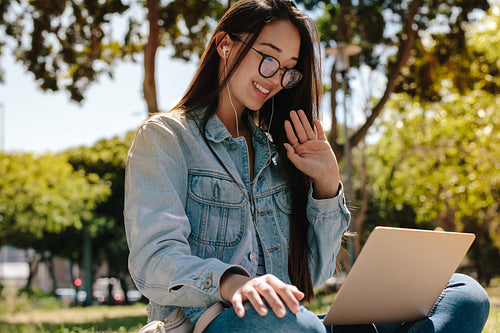 Girl doing a video chat sitting outdoors