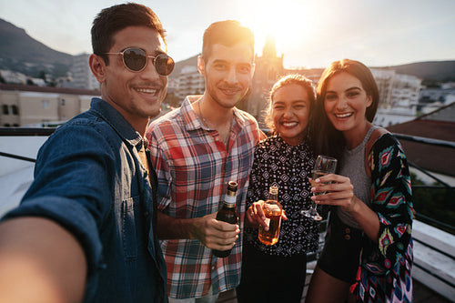 Young friends partying together taking selfie