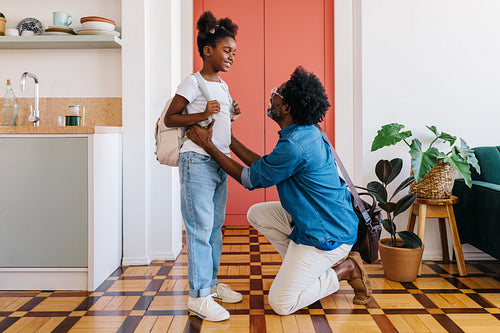 Working dad saying goodbye to his daughter before she leaves for school