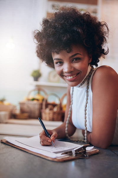 Smiling young woman working in a juice bar