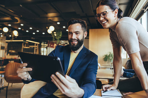 Two businesspeople taking a video call in a co-working space