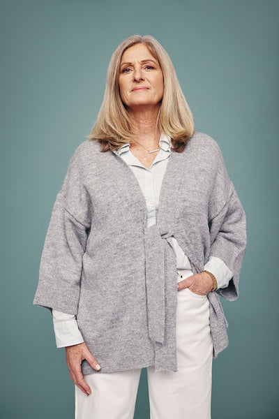 Mature woman standing alone in a studio