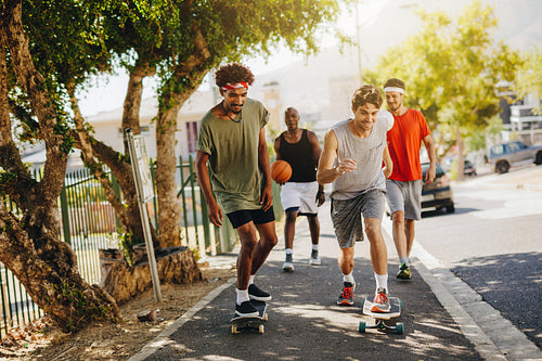Men skating on skateboard on pavement