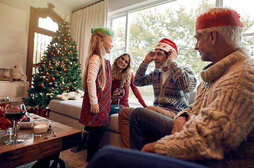 Happy family with santa hat and crown on christmas eve