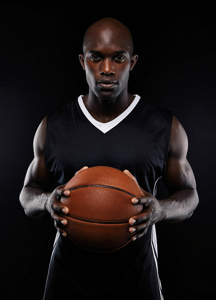 Portrait of male basketball player with a ball 