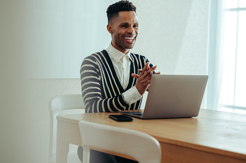 Smiling professional during virtual meeting in a modern office setting