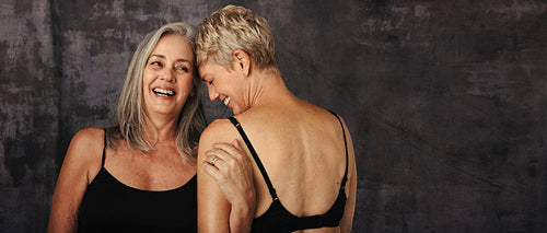 Two mature women embracing each other