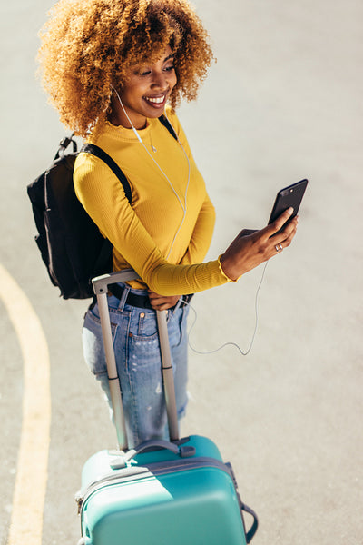 Woman traveller standing on street waiting for a cab