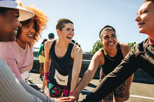 Diverse team huddle showing support and encouragement at a marathon