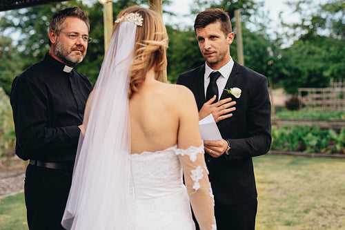 Groom reading vows at his wedding