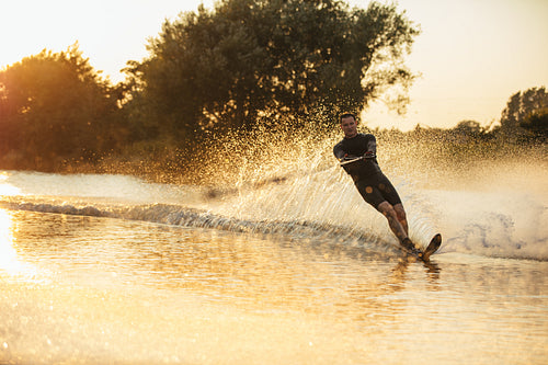 Wakeboarder surfing across the lake