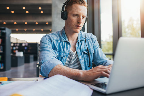 Student using laptop for university assignment
