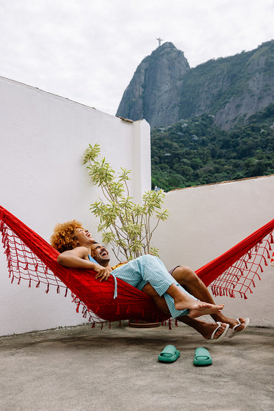 Couple relaxing in a hammock on a terrace with view of Corcovado mountain