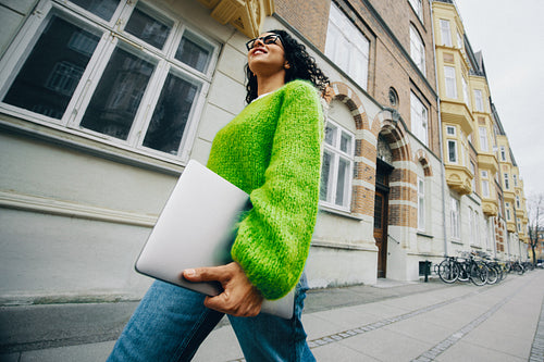 Urban movement follows the woman with a laptop as she commutes for work
