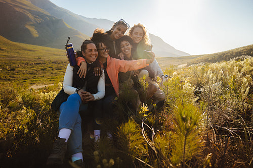 Group taking selfie in scenic mountain