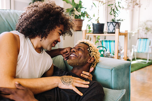 Affectionate gay couple bonding at home