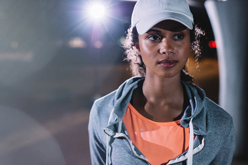 Beautiful fitness woman in the city at night